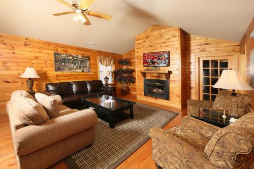 a living room with a couch and a fireplace at Cedar Falls by Eden Crest in Pigeon Forge