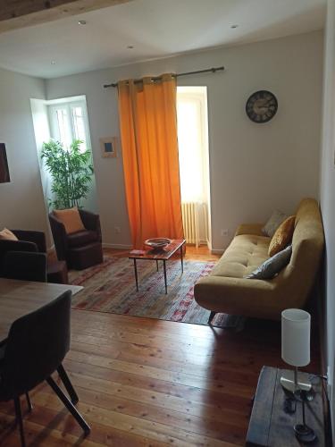 a living room with a couch and a table at Gîte de charme la belle histoire in Prades