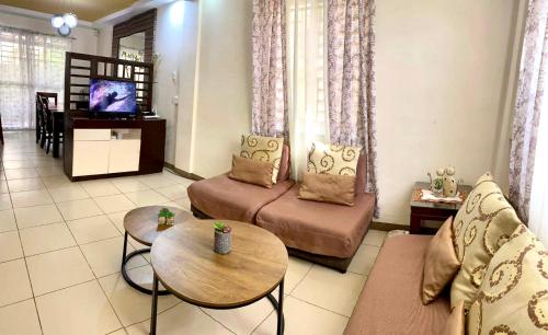 a living room with a couch and a table at Pumpkin Transient House in San Fernando