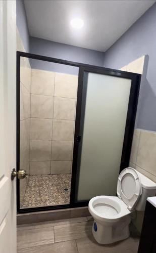 a bathroom with a shower with a toilet in it at Rancho Agua Fria in Jucuarán