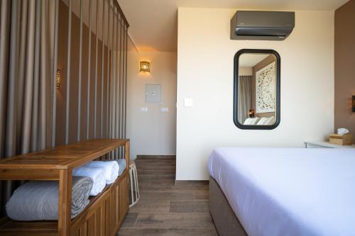a bedroom with a bed and a mirror at Exotic Sea Boutique Adults Only in Protaras