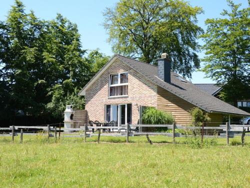 a brick house with a fence in front of it at Picture perfect Holiday Home in Sourbrodt with Garden BBQ in Sourbrodt