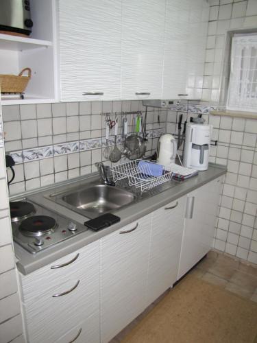 a kitchen with a sink and a counter top at Haus Roseneck Seebad Ückeritz auf Insel Usedom Vermietung im Bereich Souterrain ! in Ueckeritz
