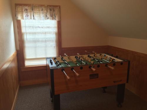 a room with a large wooden table in front of a window at Cherry Blossom by Eden Crest in Pigeon Forge
