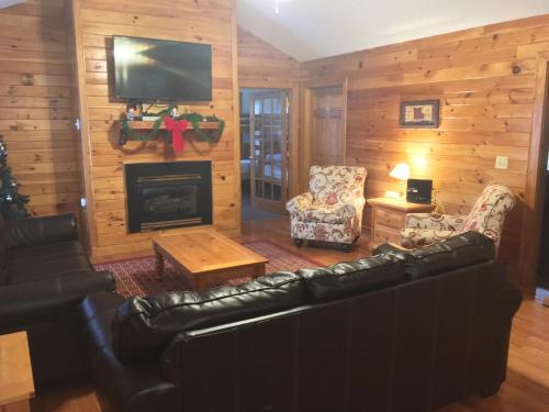 a living room with a couch and a fireplace at Cherry Blossom by Eden Crest in Pigeon Forge