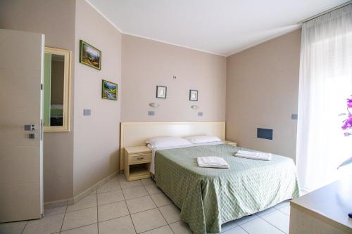 a small bedroom with a bed and a window at Di Matteo Hotel in Roseto degli Abruzzi