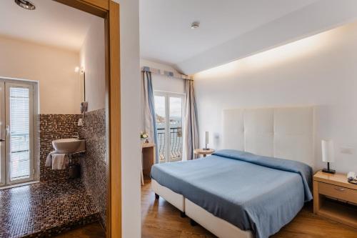 Postel nebo postele na pokoji v ubytování Bi Hotel