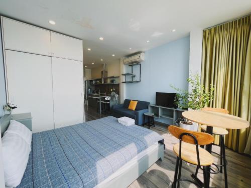 a bedroom with a bed and a table and chairs at Hanoi Home 2 - Lake View Apartment in Hanoi