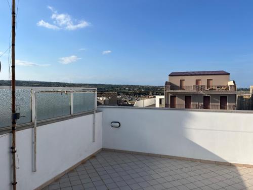 a balcony with a view of a building at Casa nel Liberty in Canicattini Bagni