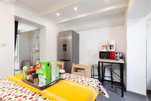 a kitchen with a table with boxes on it at Gîte rénové Calanque La Vesse in Le Rove