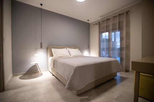 a bedroom with a bed and a large window at ONAR - LUXURY VILLAS in Argostoli