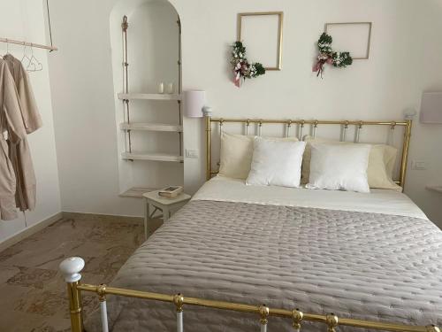 a bedroom with a large bed with white pillows at Eldoh in Bernalda
