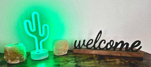 a sign that says welcome with a cactus and rocks at Indian Cove in Twentynine Palms
