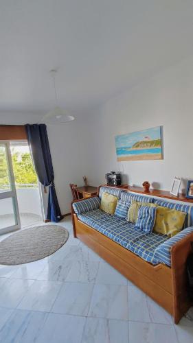 a living room with a couch in a room at LunaSol in Costa da Caparica