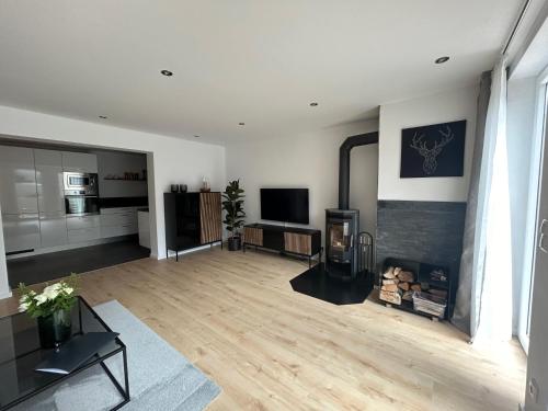 a living room with a fireplace and a television at Ferienwohnung Sophie in Schleiden