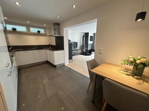 a kitchen and dining room with a wooden table and a dining room at Ferienwohnung Sophie in Schleiden