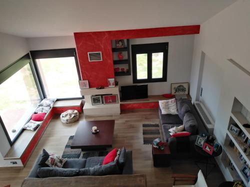 a living room with couches and a red wall at Villa Elaia in Kyparissia