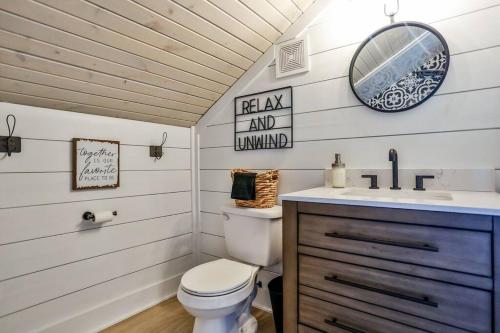 a bathroom with a toilet and a sink and a mirror at The Towpath Retreat-A Cozy Farmhouse Stay in Canal Fulton