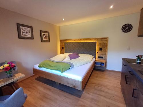 a bedroom with a large bed in a room at Apartments Haufhof , Haus im Ennstal bei Schladming in Haus im Ennstal