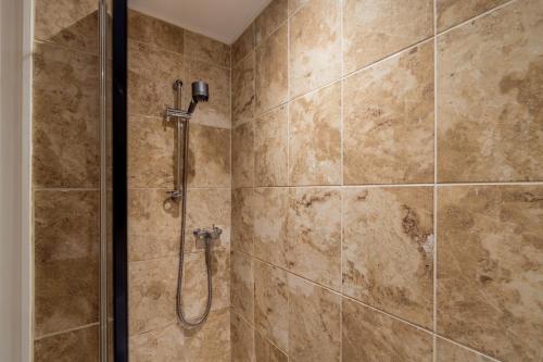 a bathroom with a shower with a glass door at Oakbank-Central Grasmere in Grasmere