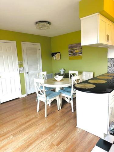 a kitchen with a table and chairs in a room at Welcome to Your Coastal Retreat in Kitty Hawk,NC in Kitty Hawk