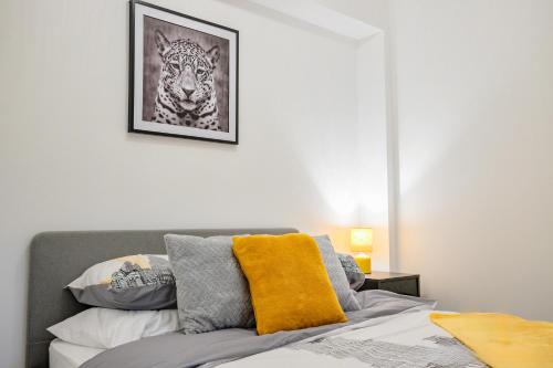 a bedroom with a bed with a tiger picture on the wall at Host & Stay - Sedlescombe Apartment in Rugby