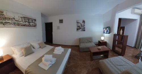 a living room with a bed and a couch at Apartmani Matković in Sutomore