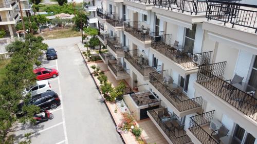 an apartment building with balconies and a parking lot at Fani Hotel in Loutra Edipsou