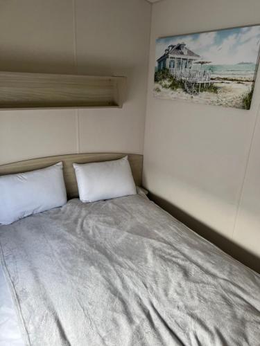 a bed with two white pillows in a room at Lyons Robin Hood , Rhyl in Rhyl