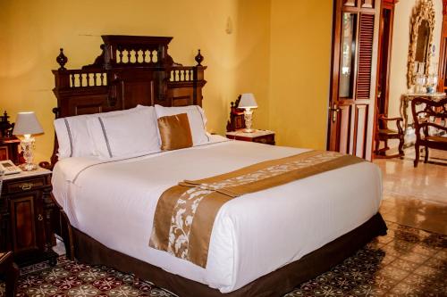 a bedroom with a large bed in a room at Hotel Boutique Casa Don Gustavo, Campeche in Campeche