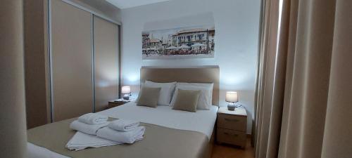 a hotel room with a bed with towels on it at Apartmani Matković in Sutomore