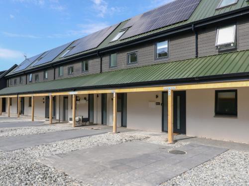 a building with solar panels on top of it at Oakbank Mews in Aberfeldy