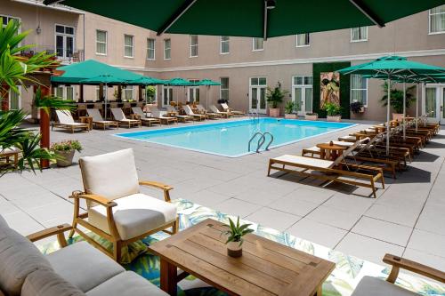 a pool with lounge chairs and a hotel at Hyatt Centric French Quarter New Orleans in New Orleans