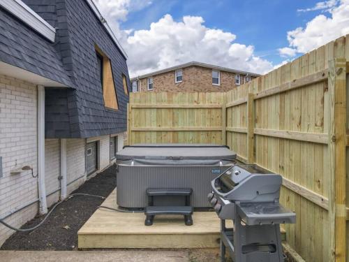 a backyard with a grill and a fence at Game Day Getaway-Play Relax Make Memories in Canton