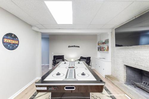 a dining room with a table and a fireplace at Game Day Getaway-Play Relax Make Memories in Canton