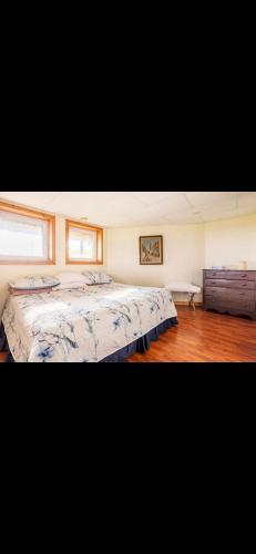a large bedroom with two beds in it at Cabot Trail - Le Château Acadian in Chéticamp