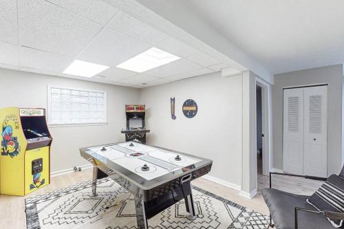a room with a ping pong table and a video game at Game Day Getaway-Play Relax Make Memories in Canton