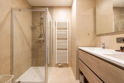 a bathroom with a shower and a sink at Casa Matti - Modern Apartment with Canal View and Terrace in Ghent