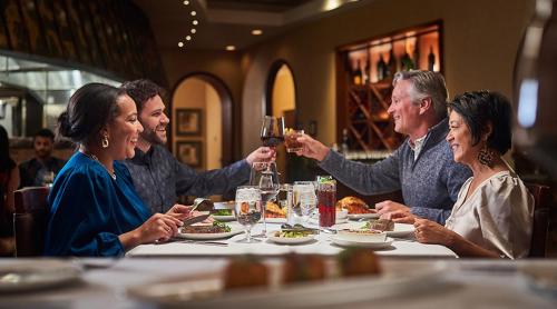a group of people sitting around a table drinking wine at Mystic Lake Casino Hotel in Prior Lake
