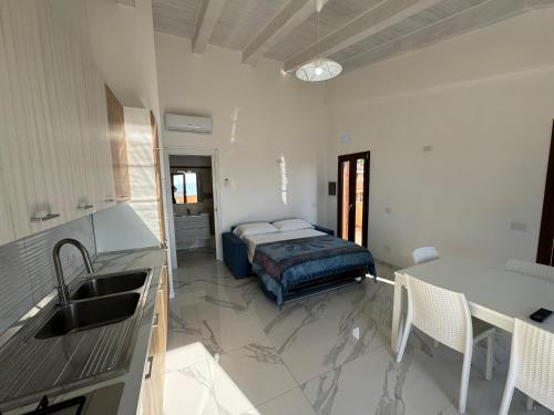 a kitchen with a bed in the middle of a room at Topazio Rooms & Apartment Tropea in Tropea