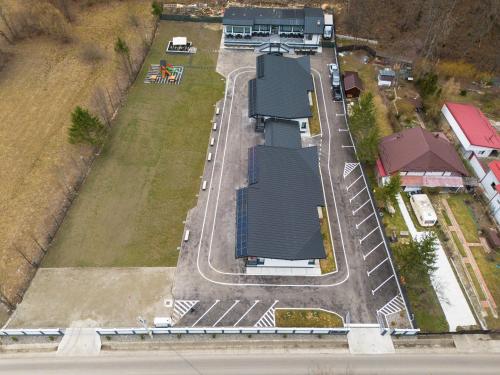 an aerial view of a house with a road at Holiday Village Tarcau in Tarcău-Gheuca