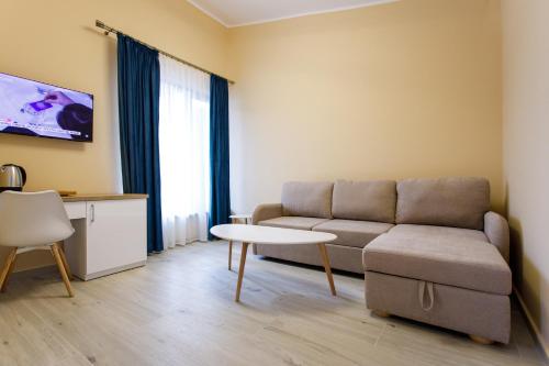 a living room with a couch and a table at Holiday Village Tarcau in Tarcău-Gheuca