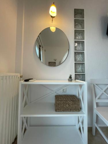 a bathroom with a white vanity with a mirror at Nepheli in Paralia Katerinis