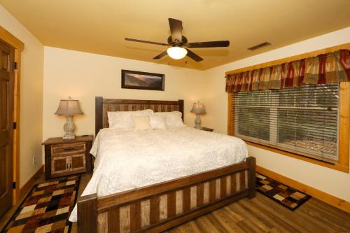a bedroom with a bed and a ceiling fan at A Breath of Fresh Air by Eden Crest in Gatlinburg