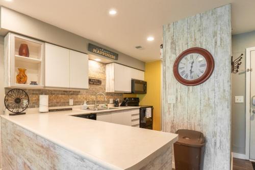 a kitchen with a large clock on the wall at Walk-in - Pools Galore - Gated Community - Golf On-Site - FREE TICKETS INCLUDED - HHK-7 in Branson