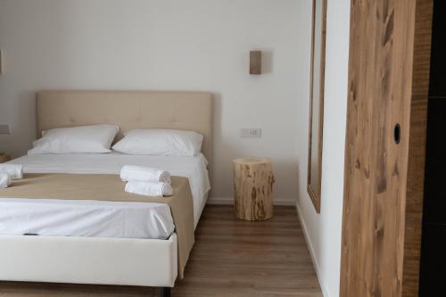 a bedroom with two beds and a wooden floor at Bellavista Kamarina Resort in Scoglitti