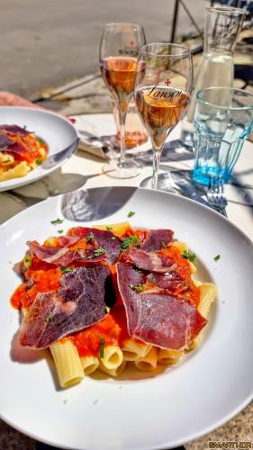 a plate of food on a table with glasses of wine at Vilajoun in Joucas