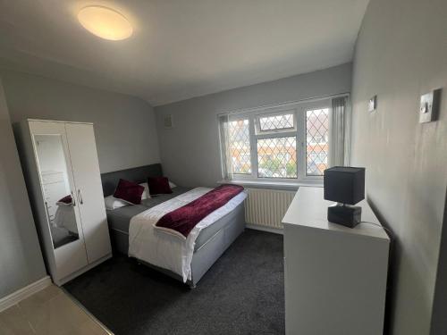 a bedroom with a bed and a mirror and a window at Premium Studio Apartment In Birmingham in Birmingham
