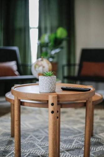 a wooden table with a remote control on top of it at Touchdown Bungalow-Charming HOF Village Home in Canton