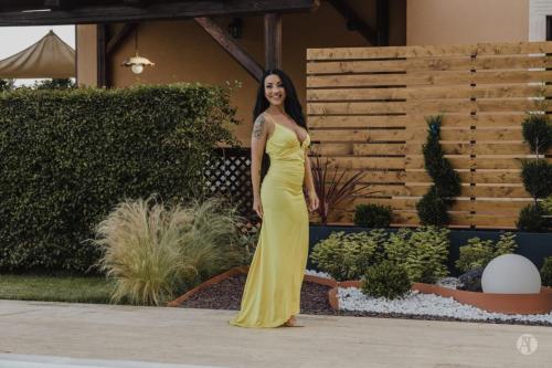 a woman in a yellow dress standing in a garden at B&B Villa Seta in Agrigento